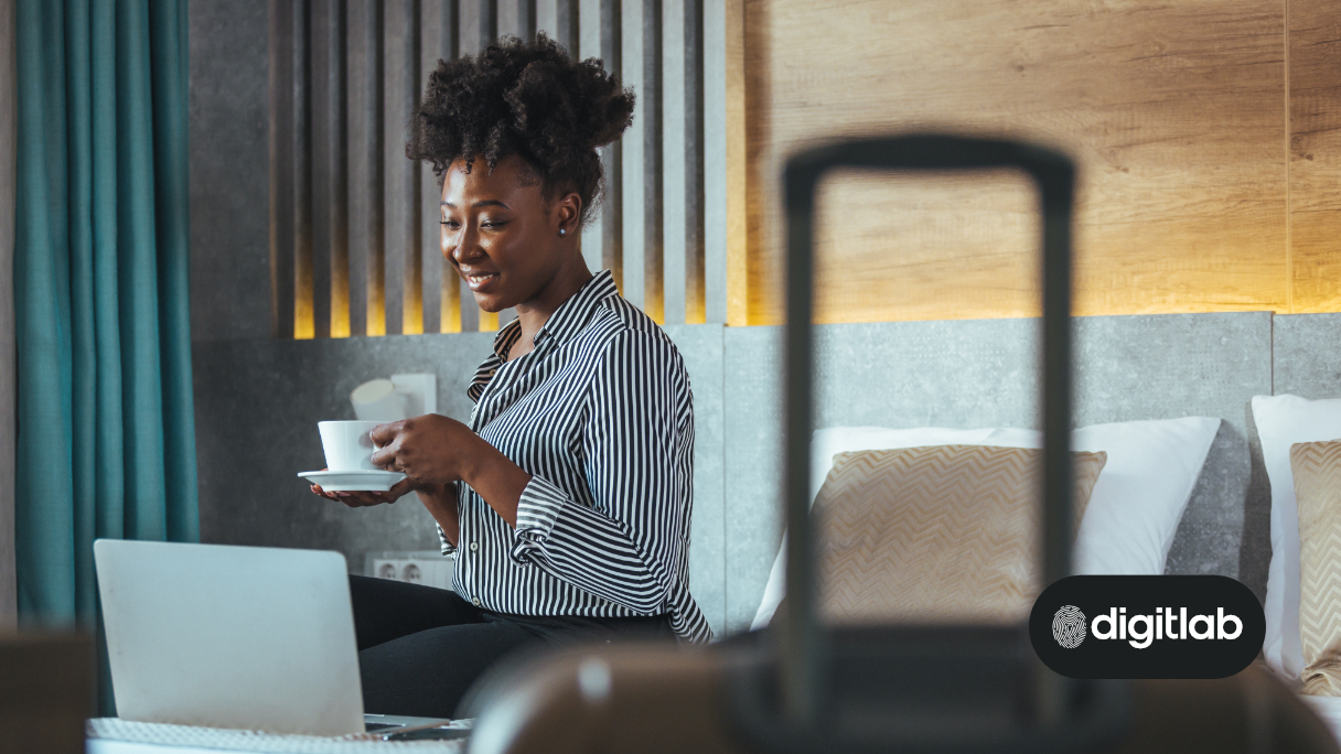 Email marketing for the hotel industry - woman holding a cup of coffee looking at a computer screen
