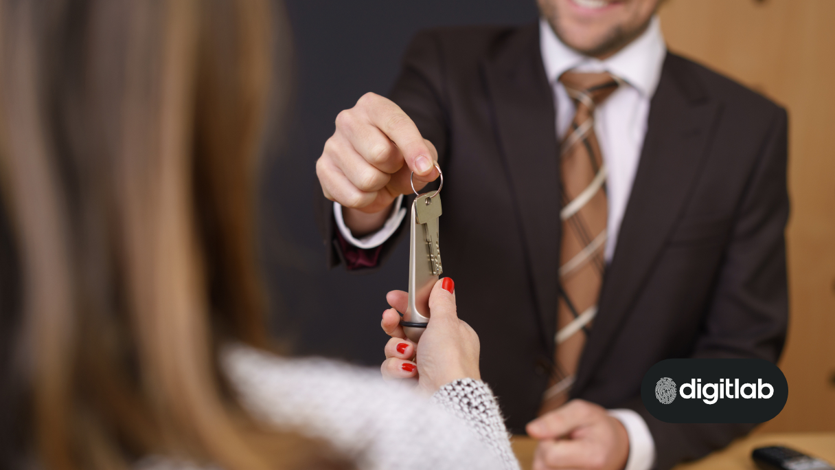 Content Strategy for Hotels - Man in a suit handing a hotel room key to a lady.