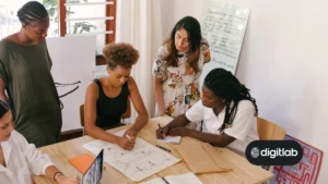 Marketing a startup on a budget - team of marketing ladies working together around a desk.