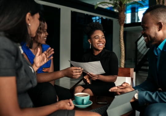 lead generation - team of marketers sitting around a coffee table