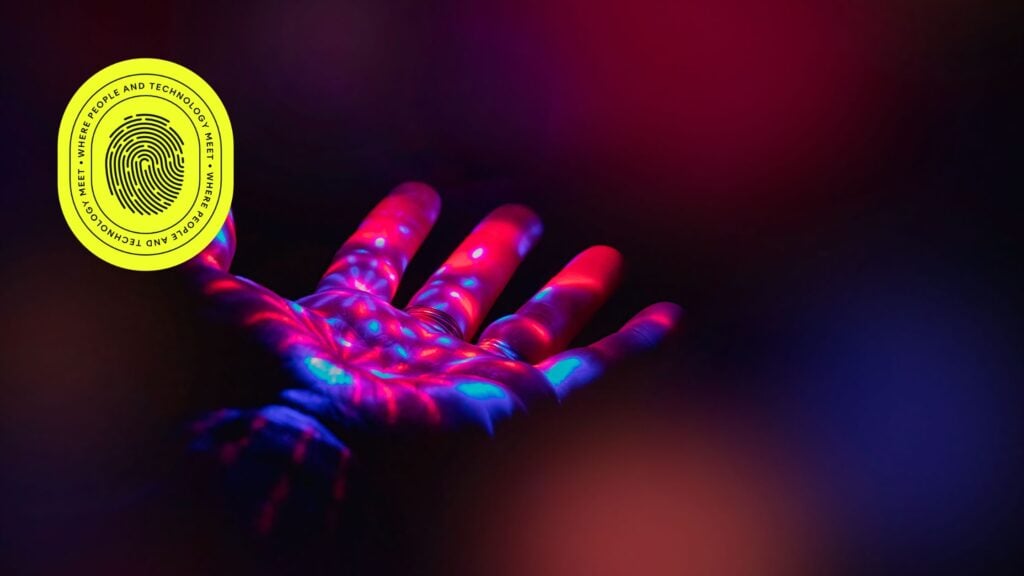 A glowing hand illuminated with vibrant red and blue lights, symbolizing technology and innovation, with a circular logo overlay, representing the creativity and precision of Google Ads campaigns