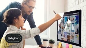 Two digital marketers collaborating on visual ad designs at a computer, illustrating the strategy and creativity behind effective Demand Gen Ads campaigns