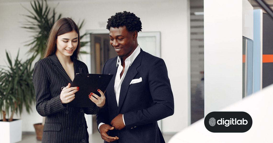 Hubspot consulting for success - woman and man in suits looking at tablet device.